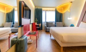 habitación superior con cama doble y sofá 

 - Hotel Ibis Styles Madrid City Las Ventas